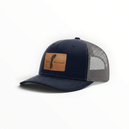 Navy trucker hat with tan patch and gray mesh back, low-profile fit