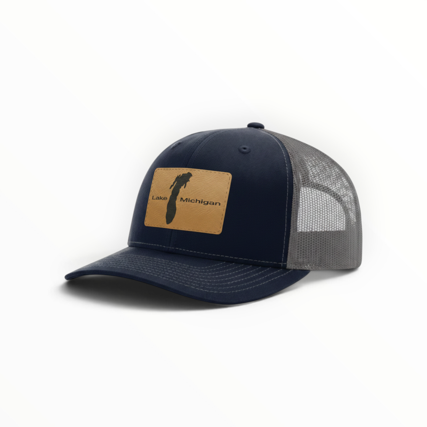 Navy trucker hat with tan patch and gray mesh back, curved brim