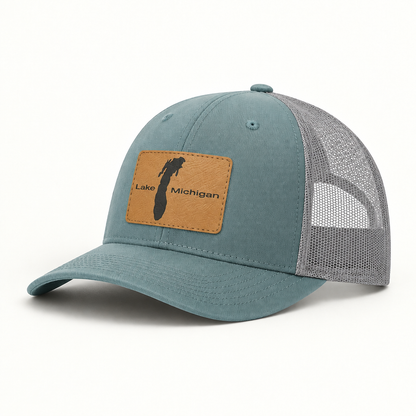 Teal trucker hat with gray mesh back and rectangular Lake Michigan patch, curved brim