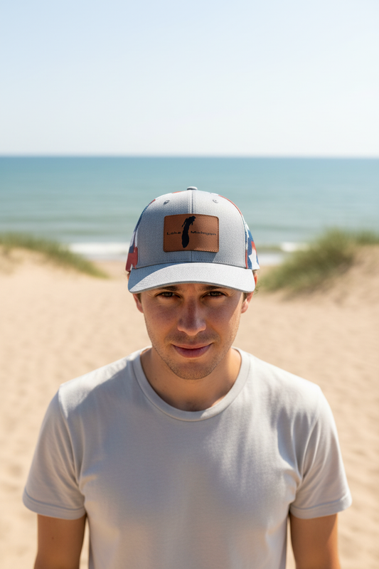 Lake Michigan leatherette patch trucker hat worn by model on sandy Lake Michigan shoreline – Keeko Designs