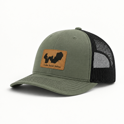 Olive green trucker hat with tan logo patch, black mesh back, curved brim, snap button