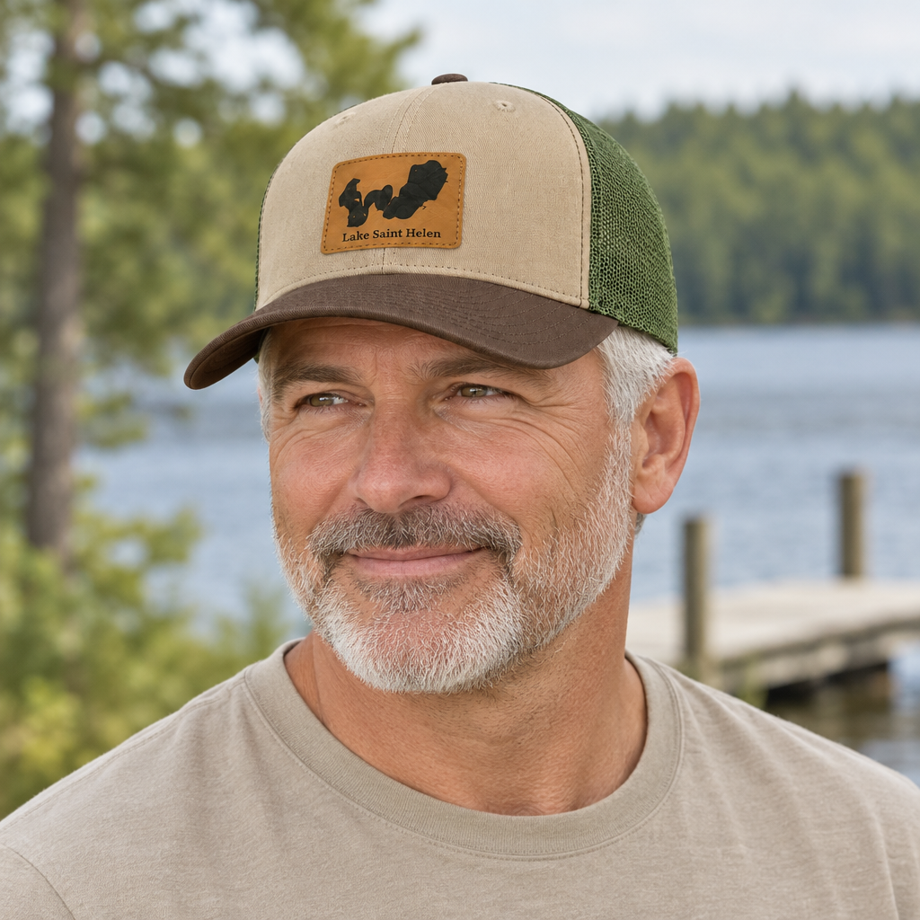 Trucker hat with tan front panel, green mesh back, and front logo patch