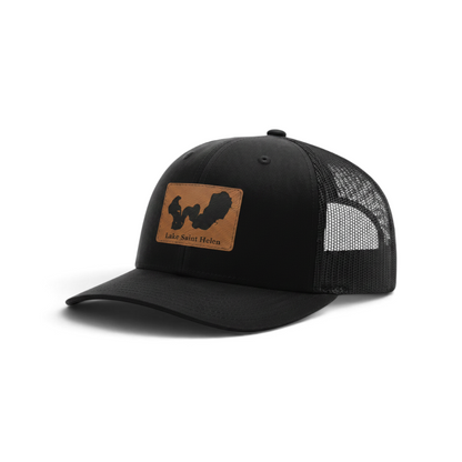 Black trucker hat with tan Lake Saint Helen logo patch and black mesh sides.