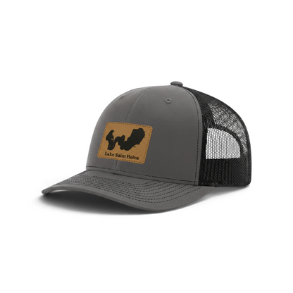 Dark gray trucker hat with black mesh and tan patch featuring Lake Saint Helen logo