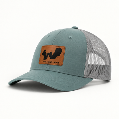 Teal trucker hat with mesh back and tan-bordered patch reading Lake Saint Helen.