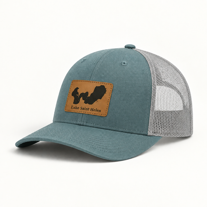 Teal trucker hat with mesh back and tan patch reading Lake Saint Helen.