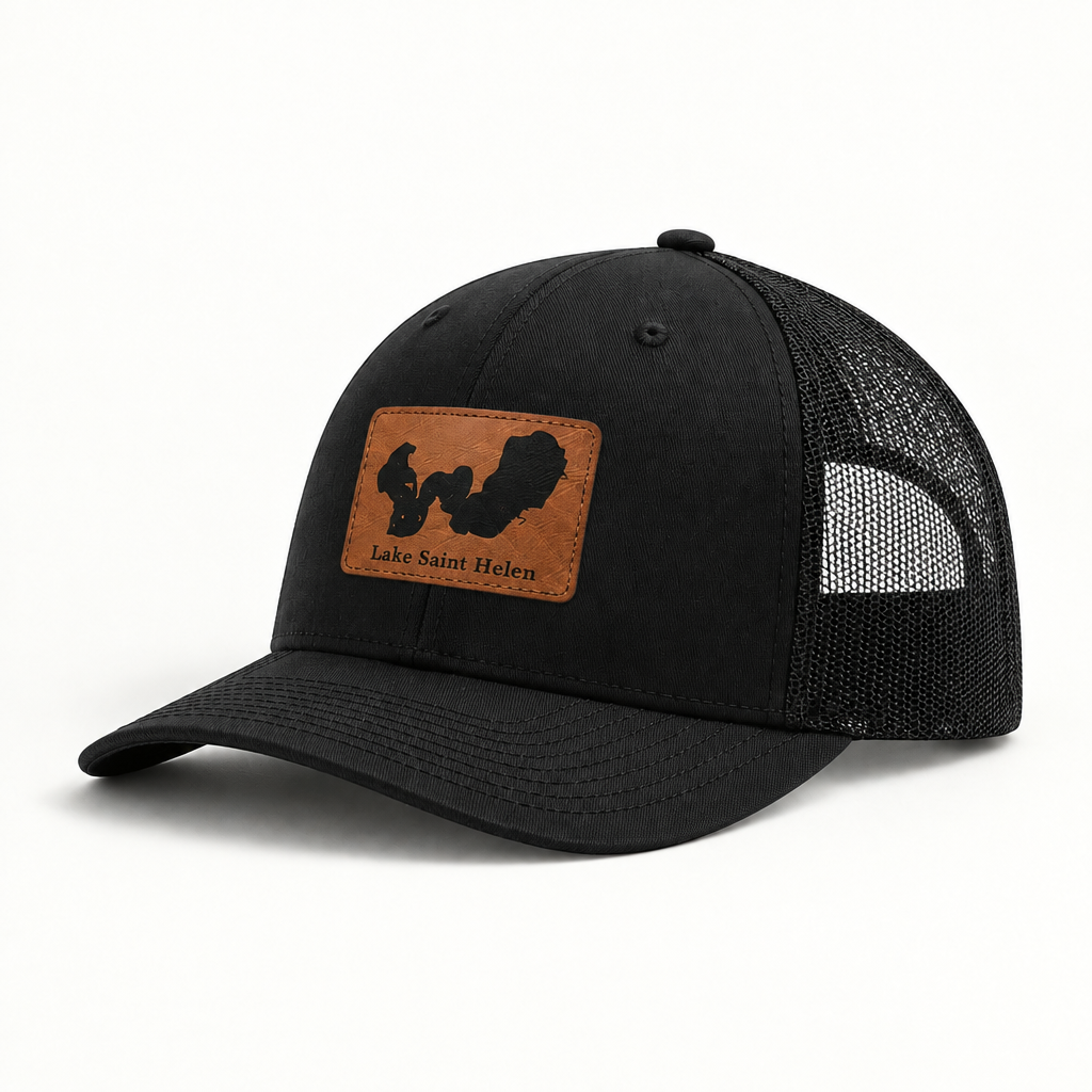 Black trucker hat with black mesh back and square patch reading Lake Saint Helen.