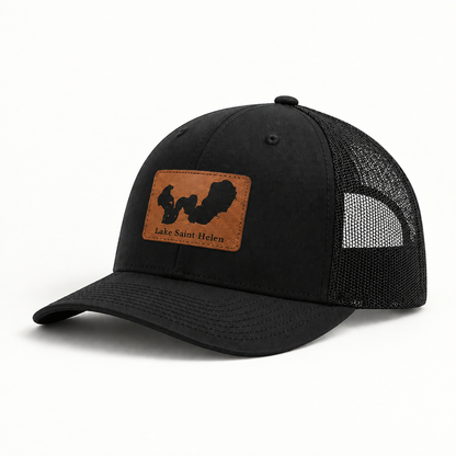 Black trucker hat with black mesh back and square patch reading Lake Saint Helen.