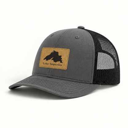 Dark gray trucker hat with black mesh back and tan “Lake Superior” patch