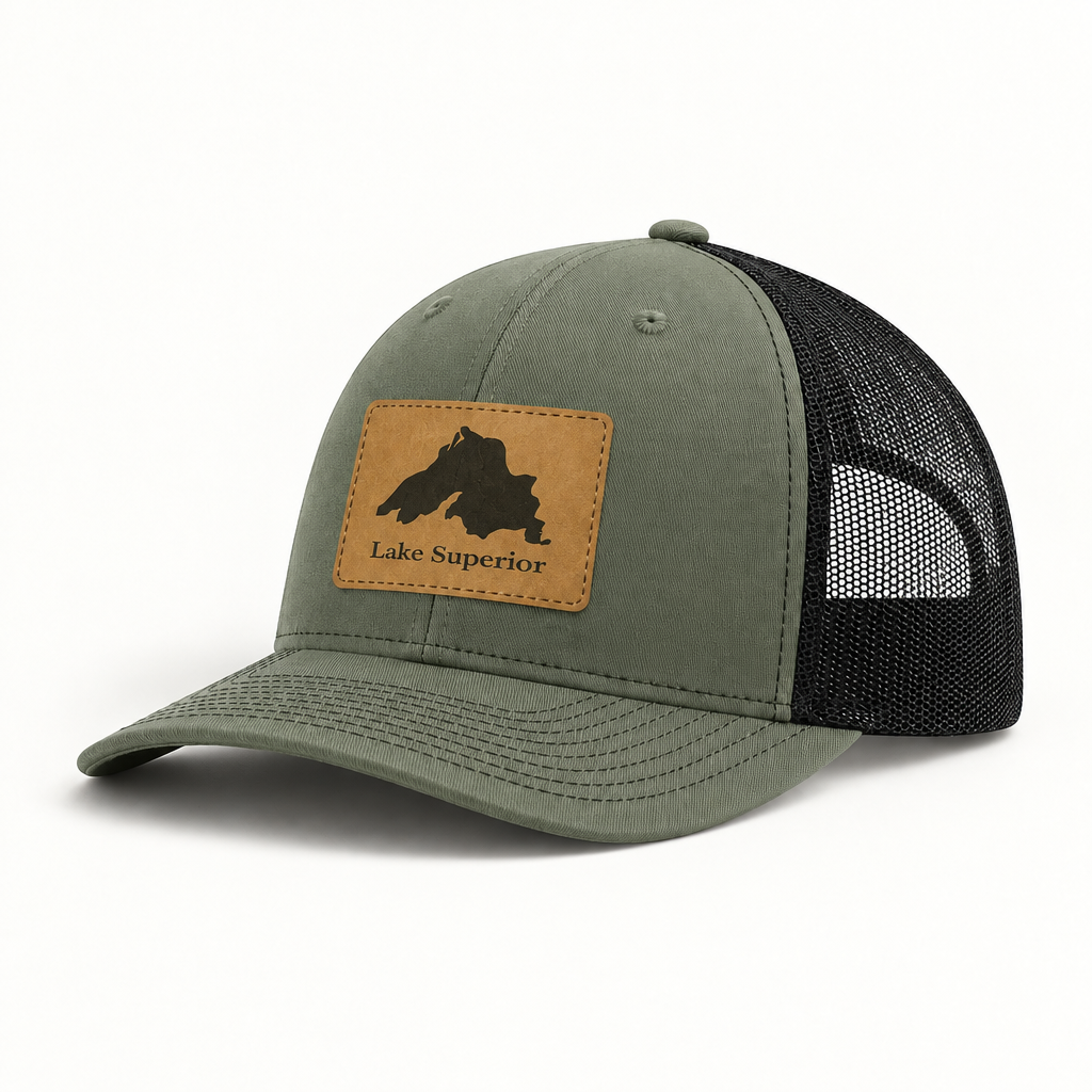 Olive green trucker hat with black mesh back and tan “Lake Superior” patch