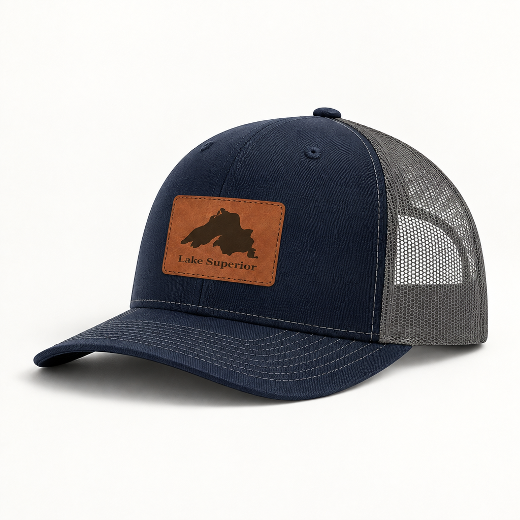 Navy trucker hat with gray mesh back and tan leather “Lake Superior” patch