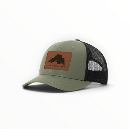 Sage green trucker hat with black mesh and brown Lake Superior patch.