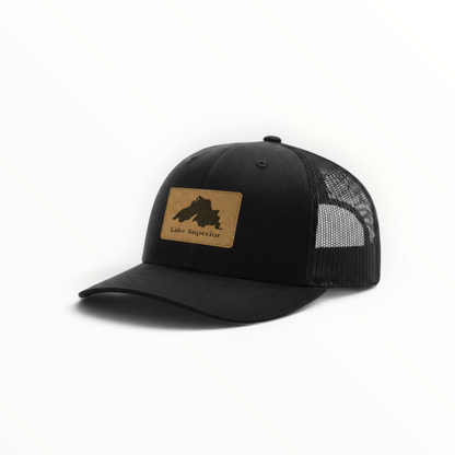 Black trucker hat with Lake Superior leather patch and mesh side panels