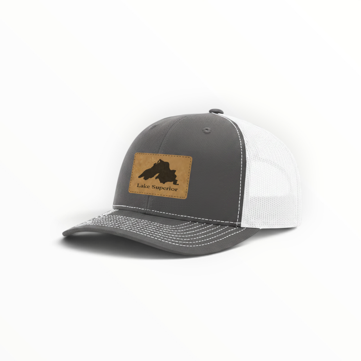 Dark gray trucker hat with white mesh and tan Lake Superior patch.