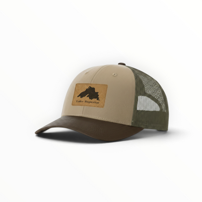 Two-tone trucker hat in tan and dark green with Lake Superior silhouette patch