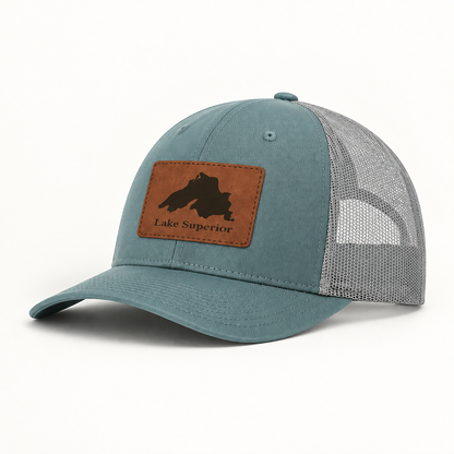 Lake Superior patch trucker hat with teal crown, gray mesh panels, curved brim