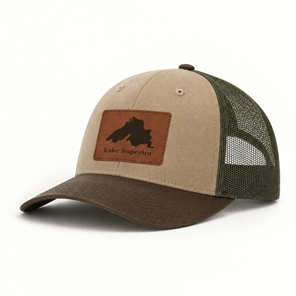 Lake Superior patch trucker hat with tan crown, green mesh back, dark brim