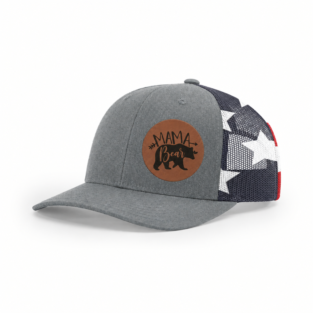Gray trucker cap with black mesh back and tan “Mama Bear” patch, side view.