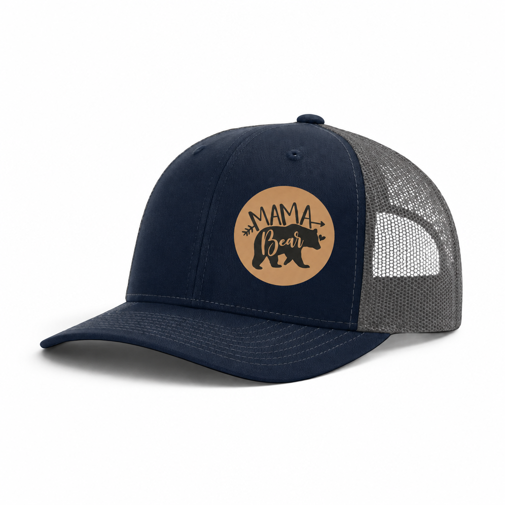 Navy and gray trucker hat with black mesh back and tan “Mama Bear” patch.