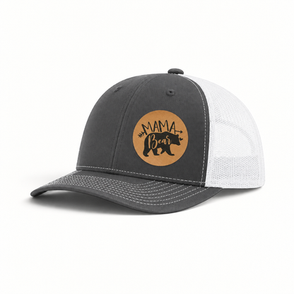Dark gray trucker hat with white mesh back and tan “Mama Bear” patch.