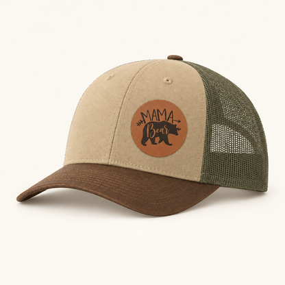 Khaki front trucker hat with tan “Mama Bear” patch and green mesh side panels.