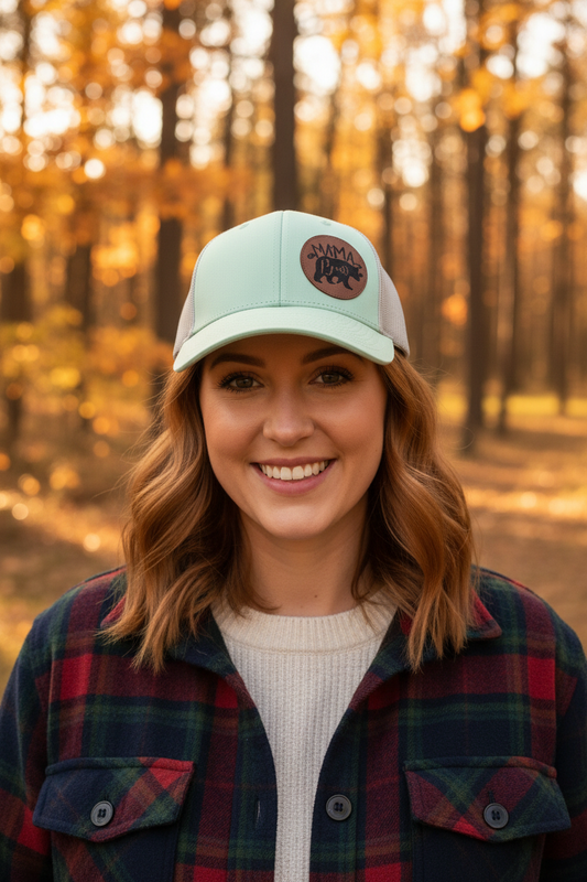 Mama Bear leatherette patch trucker hat worn by model outdoors in Michigan forest – Keeko Designs