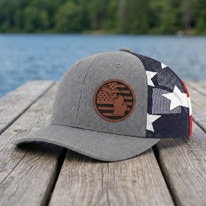 Gray trucker cap with brown circular patch and red-white-blue star-spangled panel