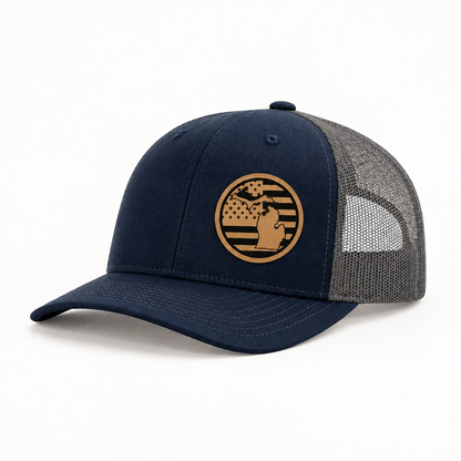 Navy trucker hat with round Michigan patch; gray mesh back