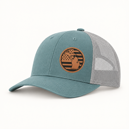 Teal trucker hat with tan Michigan patch on front and gray mesh side panels