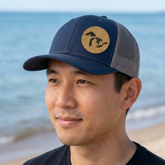 Blue trucker cap with gray mesh back, tan patch showing Michigan silhouette