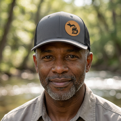 Charcoal trucker hat with tan fishing patch and mesh back