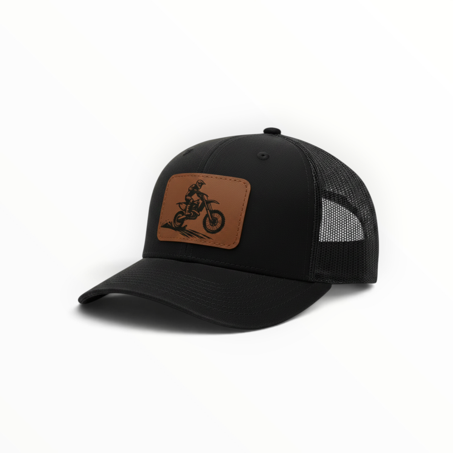 Black trucker hat with tan leather-look dirt bike patch on front.
