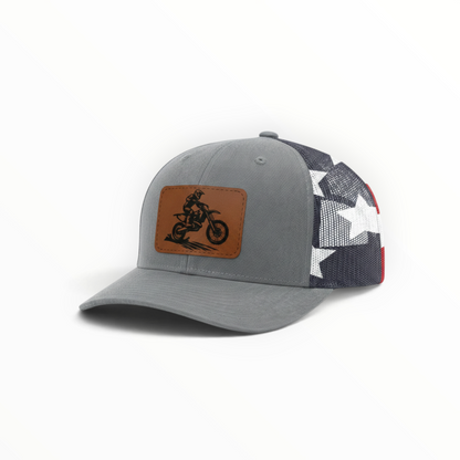 Gray trucker hat with dirt bike patch, side mesh shows white star shapes