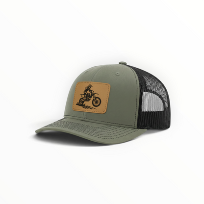 Sage green trucker hat with dirt bike patch, black mesh side panel