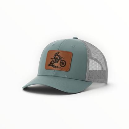 Teal trucker hat with dirt bike patch, light gray mesh side panel