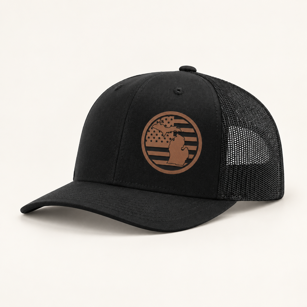 Black trucker hat with tan Michigan patch and black mesh side panels