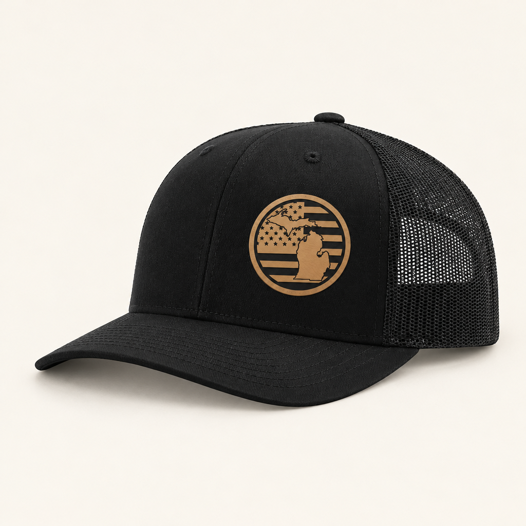 Black trucker hat with tan Michigan American-flag patch and black mesh back
