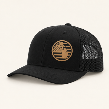 Black trucker hat with tan Michigan American-flag patch and black mesh back