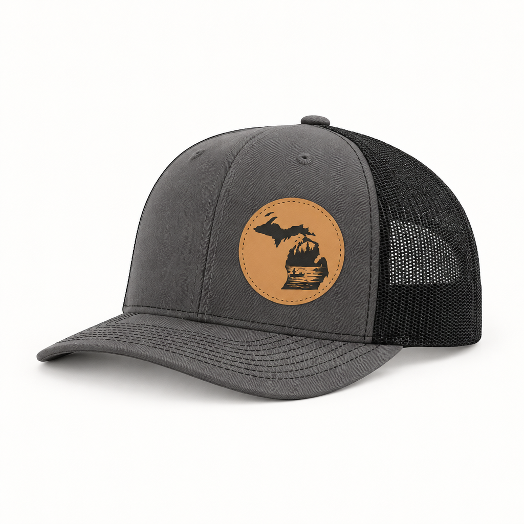 Dark gray trucker hat with tan fishing patch and black mesh side panels