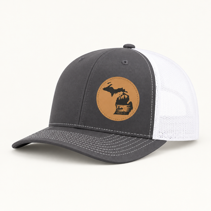 Charcoal trucker hat with tan fishing patch and white mesh side panels