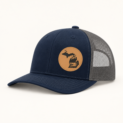 Navy trucker hat with tan fishing patch and gray mesh side panels