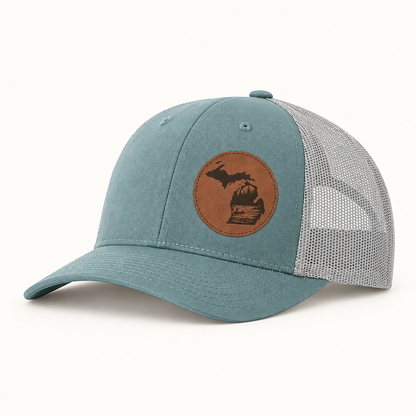 Teal trucker hat with tan fishing patch and light gray mesh back, curved brim