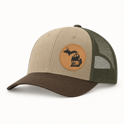 Beige trucker hat with tan fishing patch, green mesh side panels, brown brim