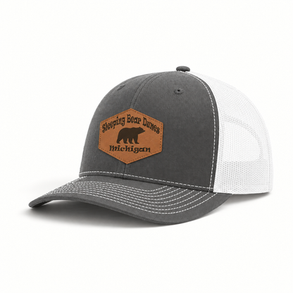 Gray trucker hat with white mesh sides and tan patch reading Sleeping Bear Dunes Michigan