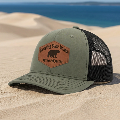 Green trucker hat with Sleeping Bear Dunes Michigan patch and black mesh sides