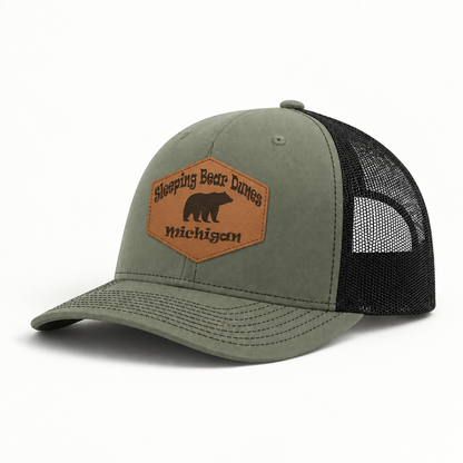 Olive green trucker hat with black mesh sides and brown patch reading Sleeping Bear Dunes Michigan