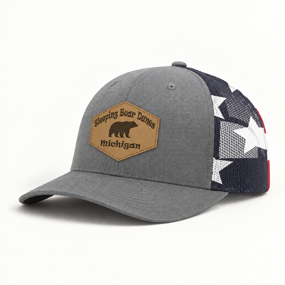 Gray trucker hat with star-pattern mesh; front patch says 'Sleeping Bear Dunes Michigan'
