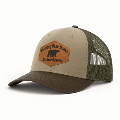 Tan trucker hat with green mesh back; oval patch with bear icon and 'Michigan'