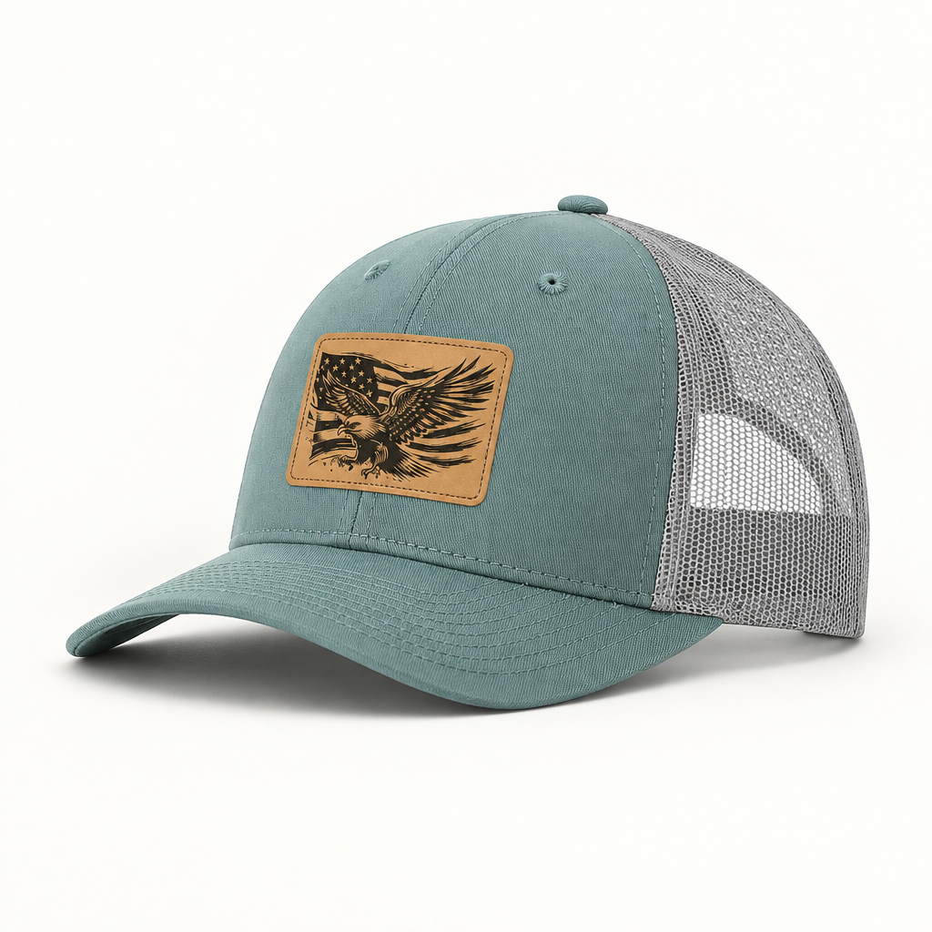 Teal and gray mesh trucker hat with American flag eagle patch, curved brim