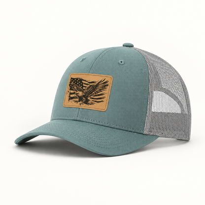Teal and gray mesh trucker hat with American flag eagle patch, curved brim